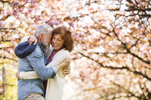 Beautiful senior couple in love outside in spring nature.