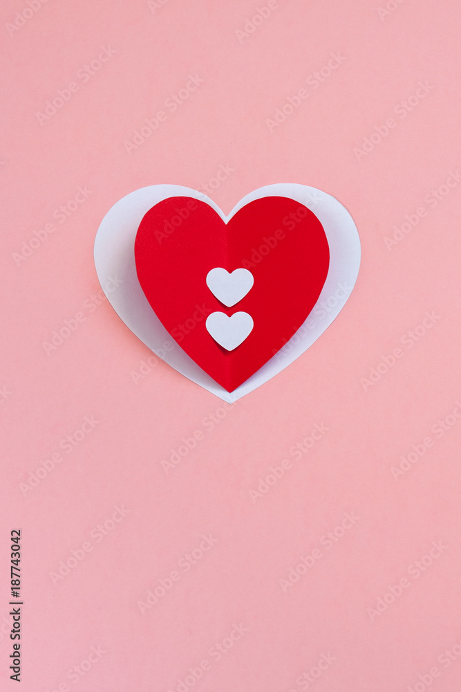 Red handmade paper heart on the pink background. Valentine's or Wedding's day postcard concept. Red handmade paper heart on the pink background. Valentine's or Wedding's day postcard concept.