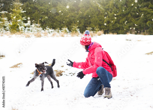 Young attractive woman playing in the snow. Winter holiday fun 