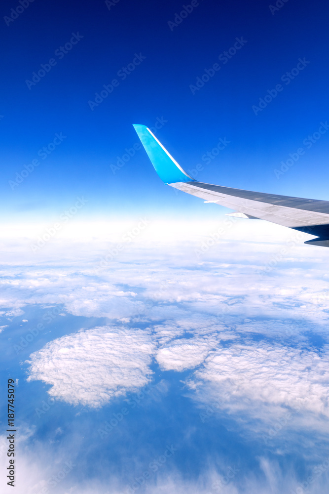 Obraz premium Clouds and sky as seen through window of an aircraft