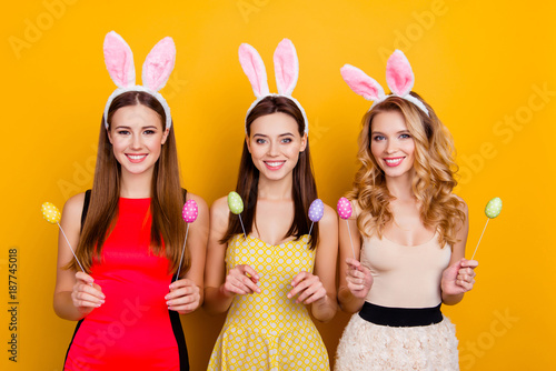 Canvas Print Happy Easter! Three pretty, trendy girls wearing bunny ears on heads in dresses