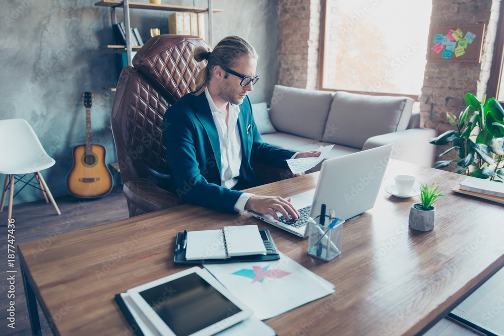 Φωτογραφία Portrait of busy blonde rich economist in glasses sitting at his desktop in work