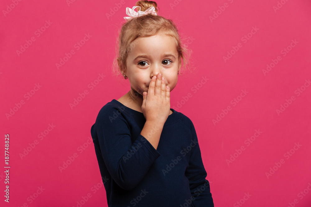 Pretty young blonde girl covering her mouth and looking aside Pretty young blonde girl covering her mouth and looking aside