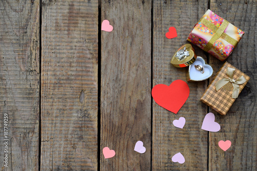 Ring and gifts on wooden board. Festive background for Birthday, Mother's day, Valentine's Day, March 8, Wedding concept greeting card. Copy space for text.