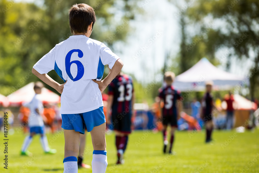Kid Soccer Player. Young Professional Football Player. Young Boys Kicking Soccer Match Kid Soccer Player. Young Professional Football Player. Young Boys Kicking Soccer Match