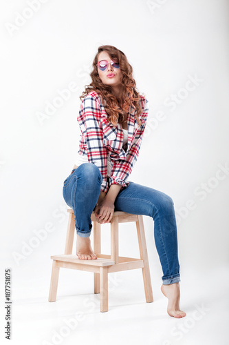 woman in jeans, plaid shirt and sunglasses © producer