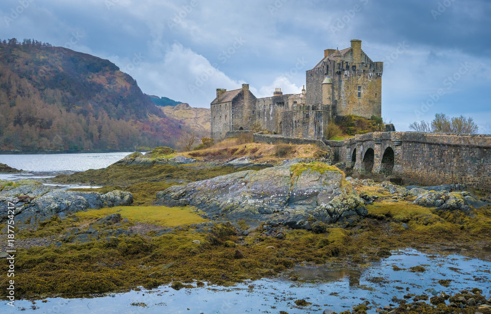 Fototapeta premium Ruins of the Eilean Donan castle, built on a a small tidal island where three sea lochs meet, Loch Duich, Loch Long and Loch Alsh, in the western Highlands of Scotland