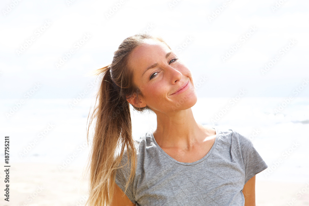 attractive young woman smiling by the sea attractive young woman smiling by the sea