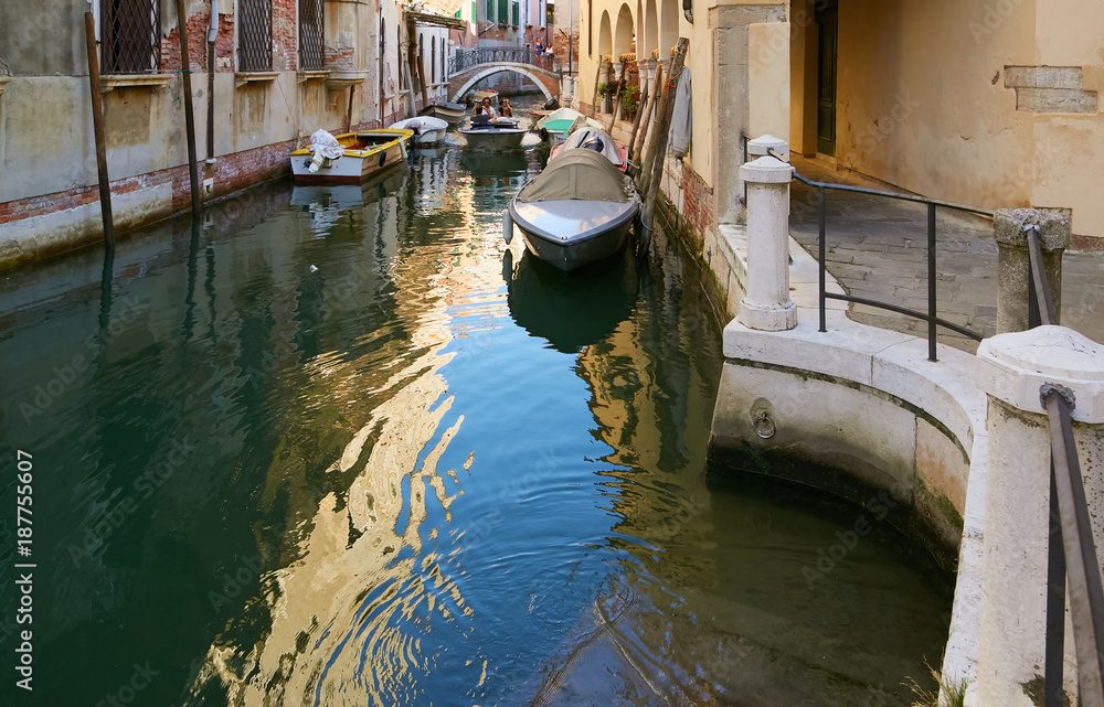 Venice, Italy - August 14, 2017: Venice canal with boats and classic buildings.