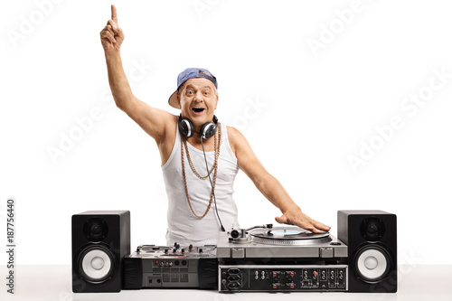 Cheerful old DJ playing music on a turntable and holding his finger up