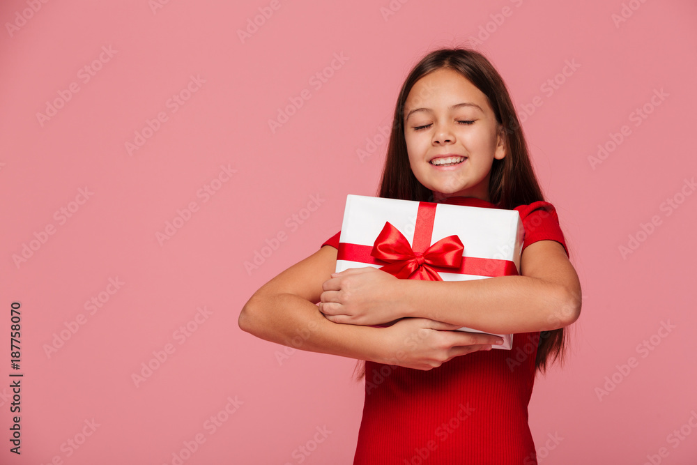 Happy girl hug her gift and smiling isolated Happy girl hug her gift and smiling isolated