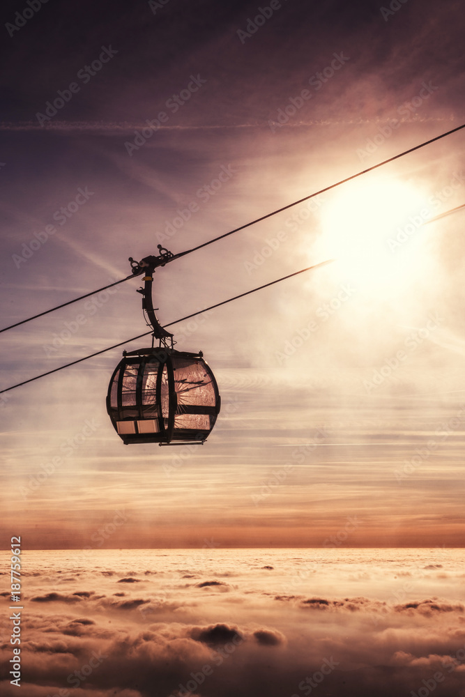 cable car in winter mountain, inverse scenery in sunrise