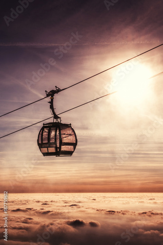 cable car in winter mountain, inverse scenery in sunrise