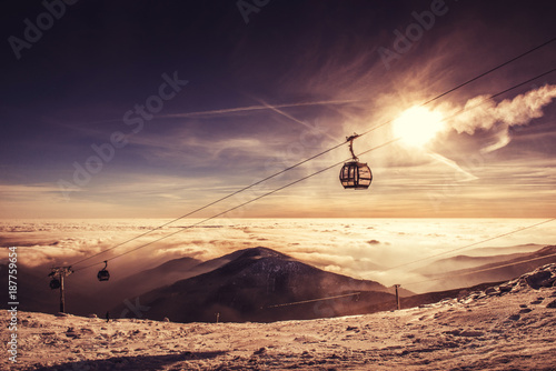 cable car in winter mountain, inverse scenery in sunrise photo