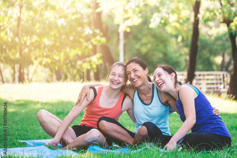 Activities in the family, mother and daughter relaxing in the park after practicing yoga. Activities in the family, mother and daughter relaxing in the park after practicing yoga.