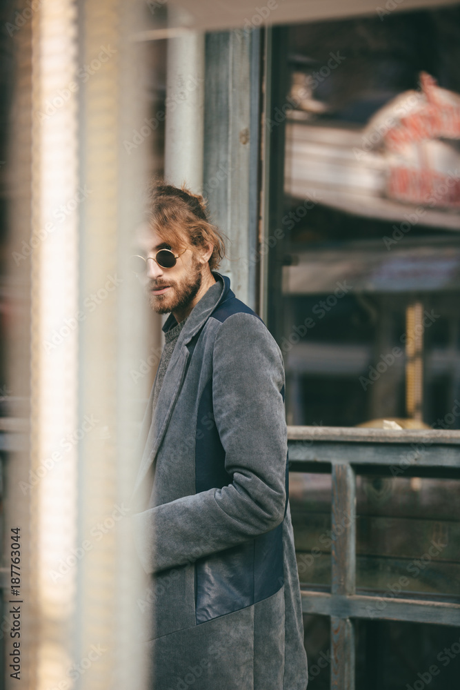 Portrait of a stylish bearded man dressed in coat walking Portrait of a stylish bearded man dressed in coat walking