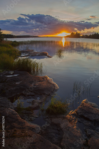 Fototapeta Naklejka Na Ścianę i Meble -  Picturesque bright sunset on the lake in Finland