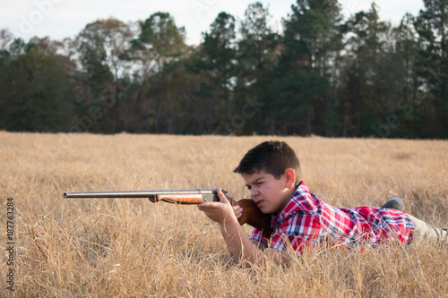 Young boy with a shotgun