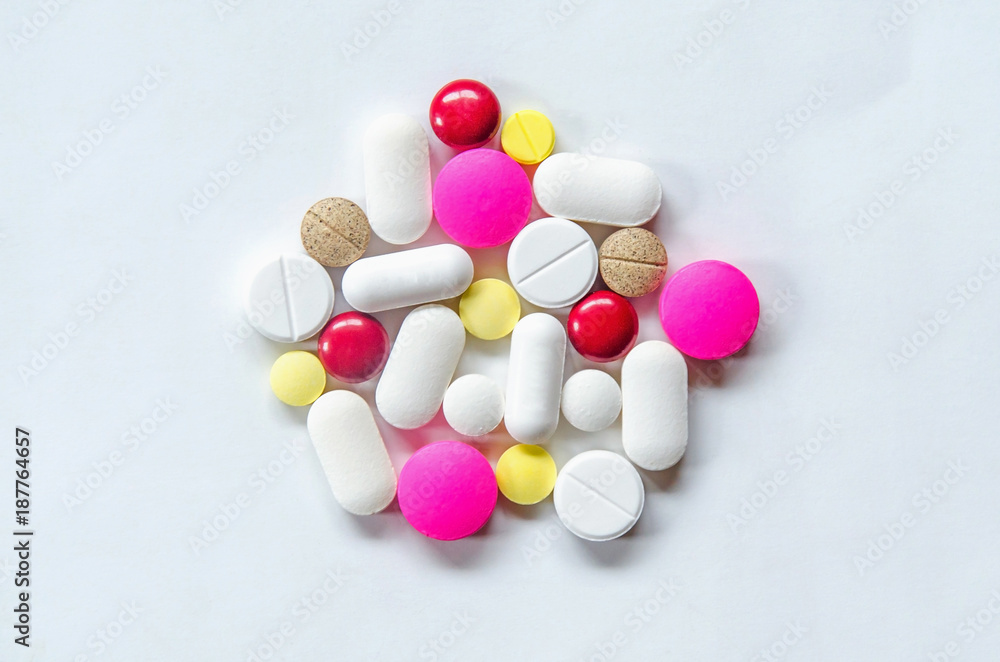 Top view of the pills on the white background, The drug and capsule pills on the floor, Pile of the drug and pills on the white background. Top view of the pills on the white background, The drug and capsule pills on the floor, Pile of the drug and pills on the white background.