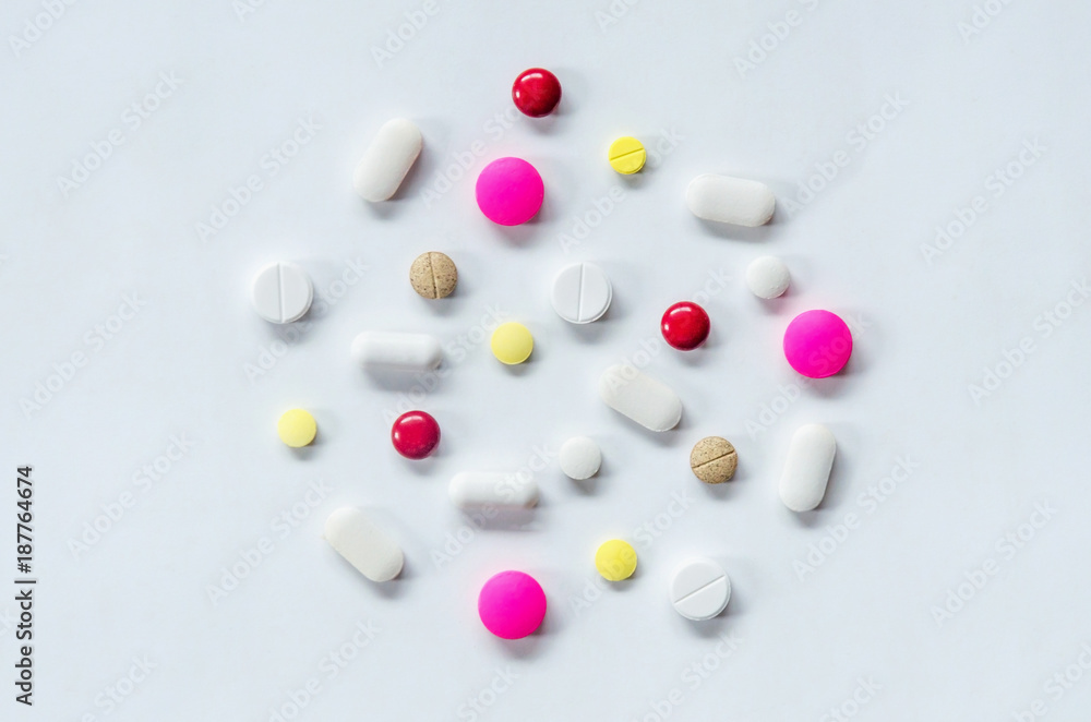 Top view of the pills on the white background, The drug and capsule pills on the floor, Pile of the drug and pills on the white background. Top view of the pills on the white background, The drug and capsule pills on the floor, Pile of the drug and pills on the white background.