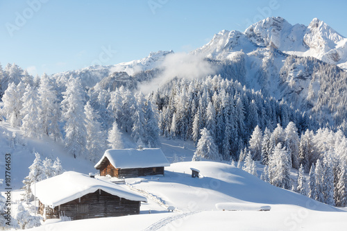 Winter wonderland in Austrian Alps. Beautiful winter scenery with frozen trees and traditional alpine hut