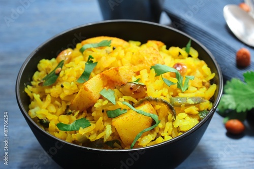 Batata Poha / Indian breakfast with potatoes and flattened rice, selective focus