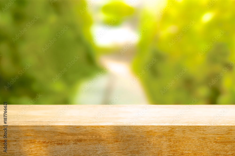 Empty wooden table on blurred garden background, front view. Empty wooden table on blurred garden background, front view.