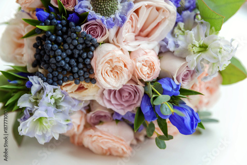 close up of gentle bouquet of the bride in pastel colors with pink roses