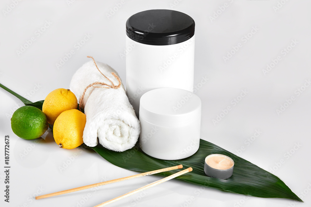 White bottles and two whole lemon and lime isolated on white background. The concept for advertising cosmetics White bottles and two whole lemon and lime isolated on white background. The concept for advertising cosmetics