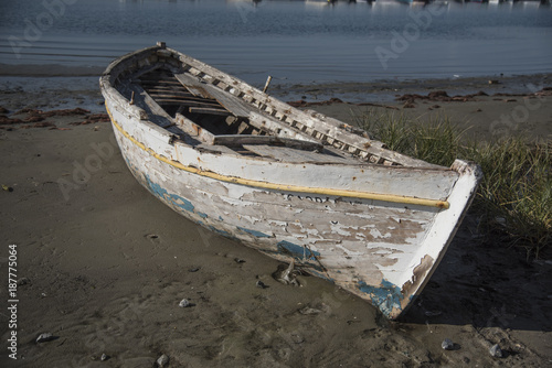 The old boat abandoned on the shore