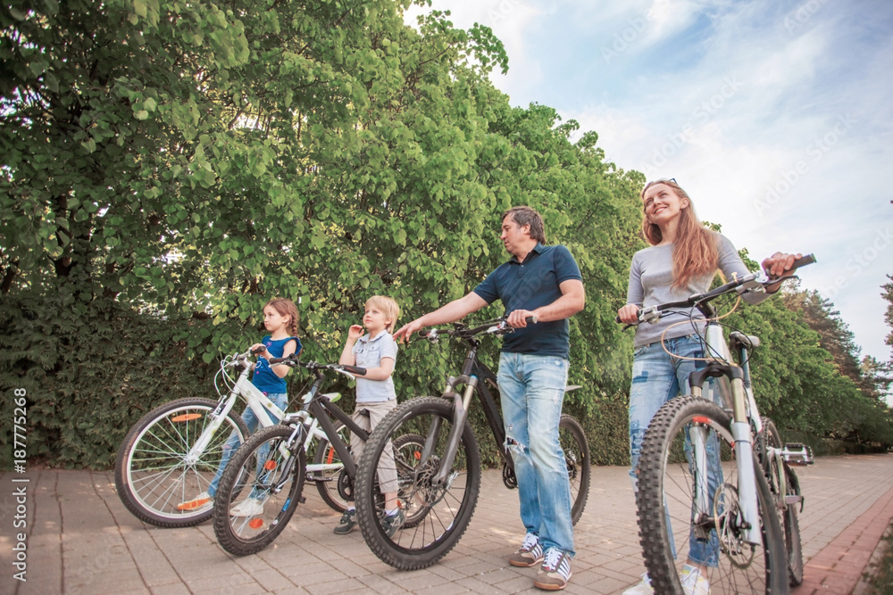 The family in the park on bicycles