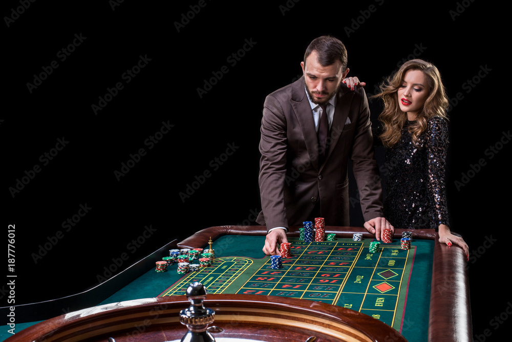 Man with woman playing roulette at the casino. Addiction to the Man with woman playing roulette at the casino. Addiction to the