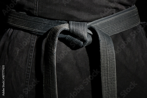 Black judo, ju-jitsu, or karate belt on a black kimono