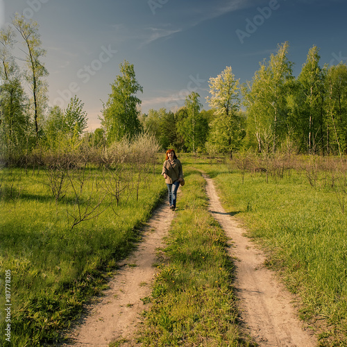  woman goes for a walk in the spring forest.