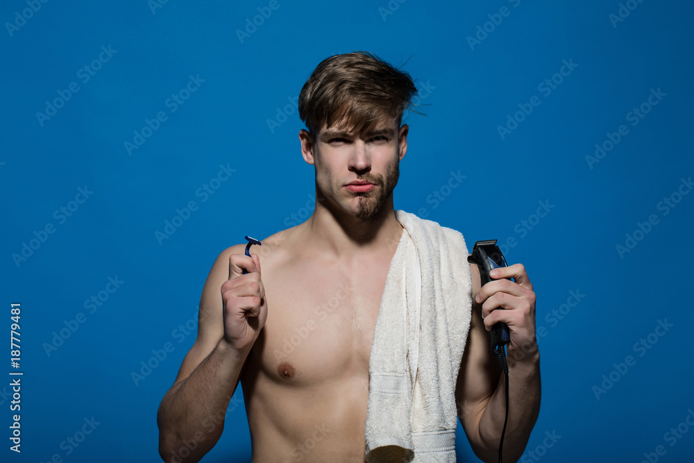 Macho with half bearded face, bath towel on muscular torso Macho with half bearded face, bath towel on muscular torso