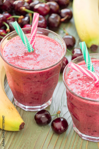 Two glasses of cherries and bananas smoothie.