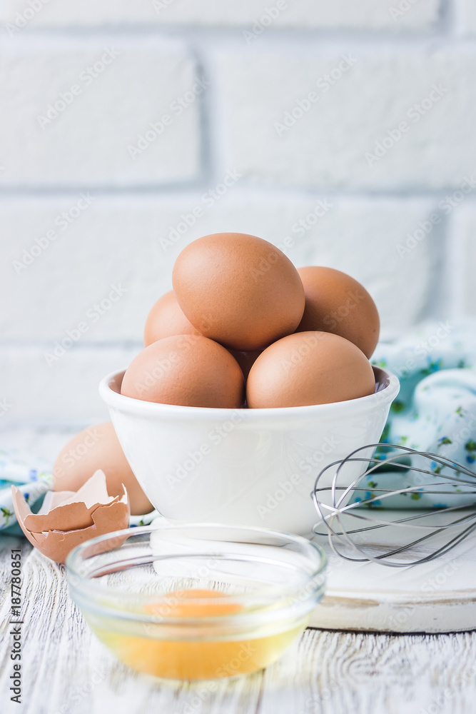Raw farm eggs in a bowl on white background. Selective focus, copy space. Raw farm eggs in a bowl on white background. Selective focus, copy space.
