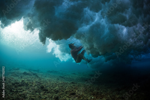 Photography Lady surfer struggles during wipe out in the ocean