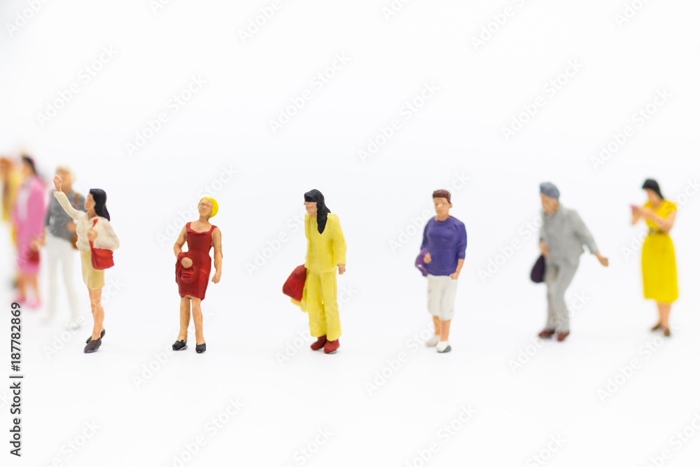 Miniature people: Group of women standing together, used to announce the International Working Women's Day. The definition is: Bread with roses for economic success. Miniature people: Group of women standing together, used to announce the International Working Women's Day. The definition is: Bread with roses for economic success.