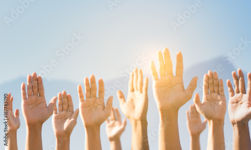People raising hands for participation, many people's hands up. teamwork and competition concept photo