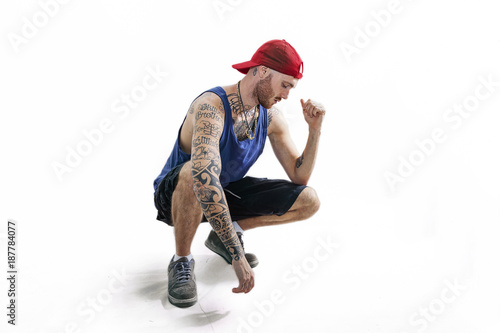 sitting tattooed rap singer posing in studio