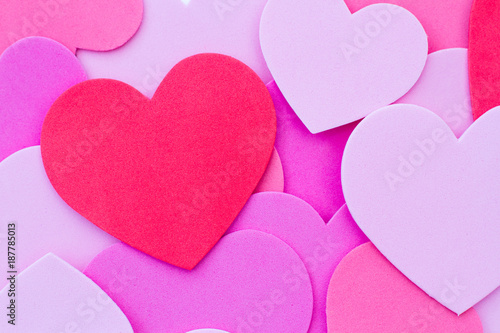 A full frame, Valentine's Day background of love hearts or heart shapes in red and pink with copy space.