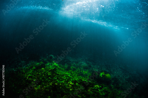 Underwater view of the coral reef in a shore with breaking waves