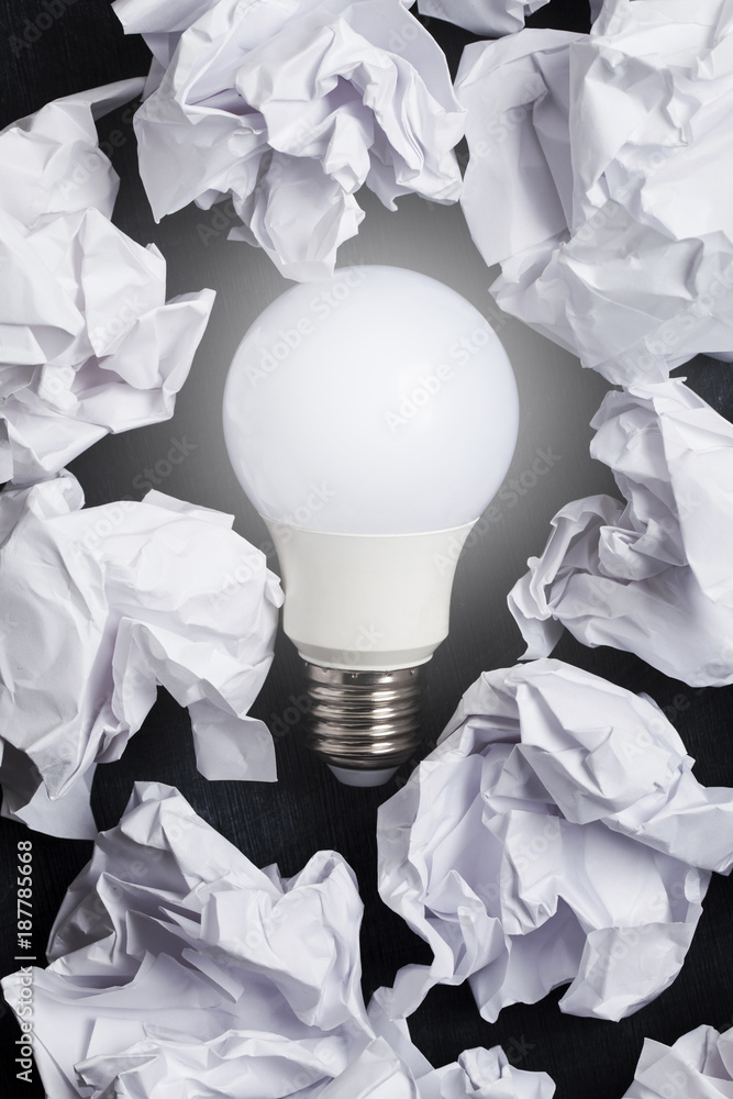 Inspiration and imagination concept. lightbulb with white crumpled ...