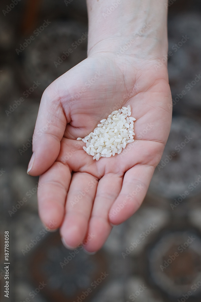 Hand of a child with rice grains Hand of a child with rice grains