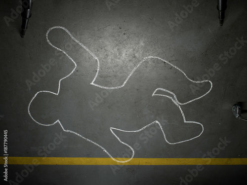 Chalk outline of human body on concrete floor 
