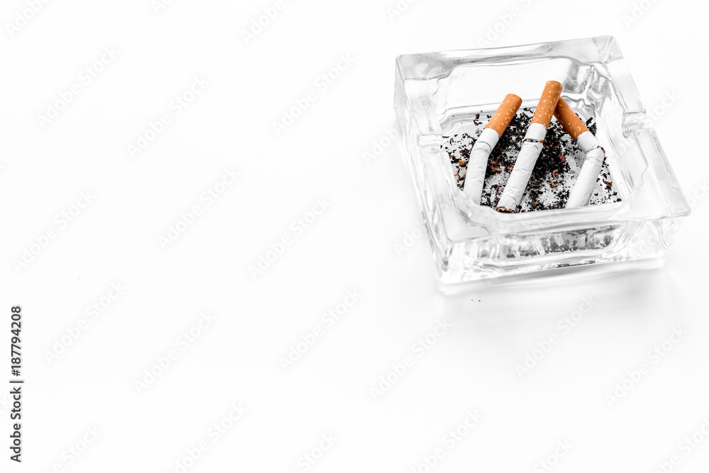 Smoking. Half-smoked cigarettes in ashtray on white background copy space Smoking. Half-smoked cigarettes in ashtray on white background copy space
