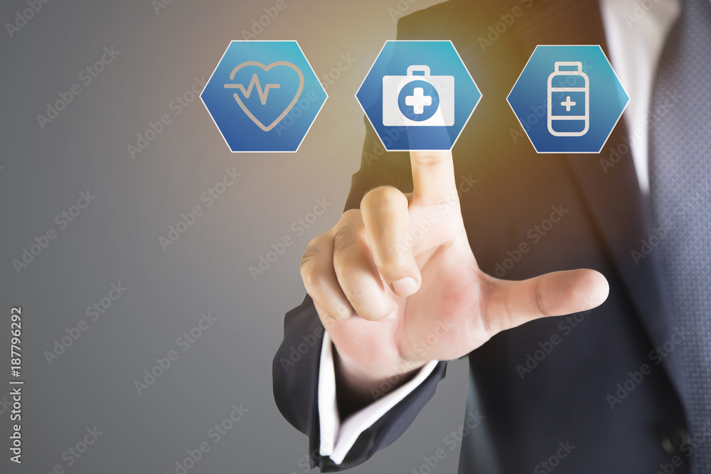 Close up of businessman touching medical icon with finger Close up of businessman touching medical icon with finger