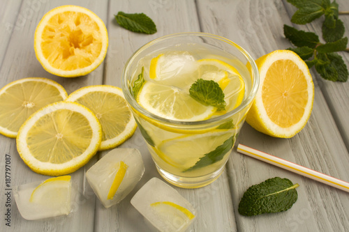 Homemade lemonade with lemon and mint on the grey  wooden background