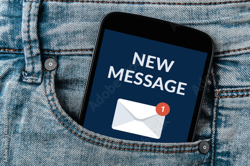 New message notification concept on smartphone screen in jeans pocket. All screen content is designed by me. 